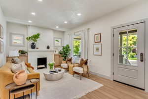 Living room with light hardwood / wood-style floors and a wealth of natural light