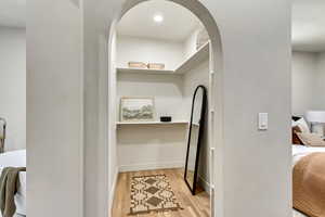 Corridor with light hardwood / wood-style floors