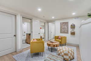 Sitting room with light hardwood / wood-style flooring