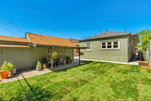 Back of property with a patio and a yard