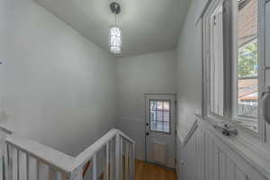 Staircase featuring wood-type flooring