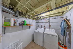 Laundry room featuring washer and clothes dryer