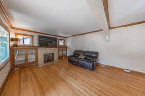 Living room featuring ornamental molding and light hardwood / wood-style floors