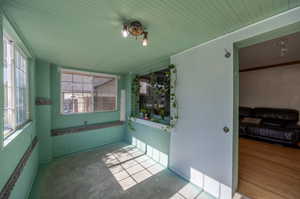 Sunroom / solarium with plenty of natural light and wood ceiling