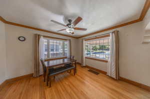 Interior space with crown molding, light hardwood / wood-style flooring, and ceiling fan