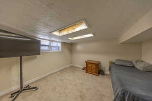 Bedroom with carpet floors and a textured ceiling