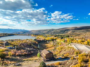 Birds eye view of property with a water and mountain view