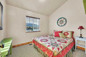 Carpeted bedroom with vaulted ceiling