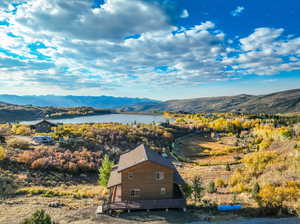 Birds eye view of property featuring a water and mountain view