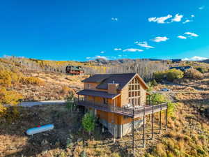 Rear view of house featuring a deck with mountain view