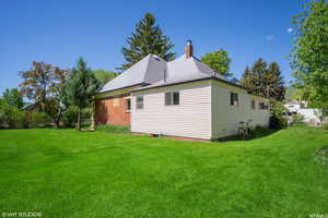 View of side of home featuring a lawn