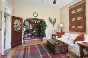 Living room featuring ceiling fan and hardwood / wood-style floors