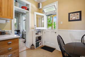 Doorway with plenty of natural light and ornamental molding