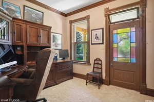 Carpeted office space featuring ornamental molding