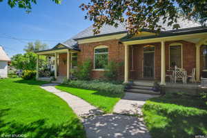 Bungalow-style house featuring a front lawn and covered porch