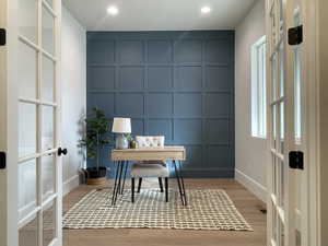 Home office with french doors and light wood-type flooring