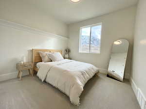 Bedroom with light colored carpet