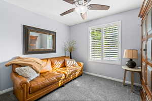 Living room with ceiling fan and carpet floors