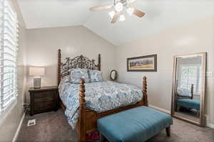 Bedroom featuring lofted ceiling, carpet, and ceiling fan