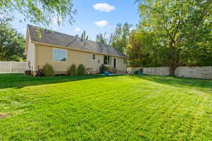 Rear view of property featuring a yard