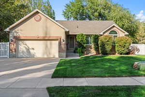 View of front of house with a garage and a front lawn