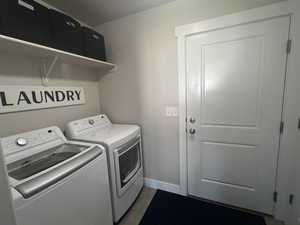 Laundry area with washer and dryer with tiled  floors