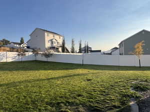 View of backyard, the vinyl fence and planted fruit trees