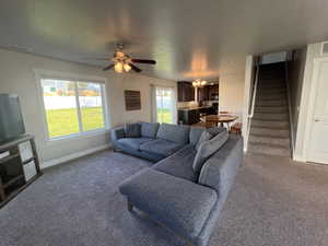 Carpeted living room w/ ceiling fan