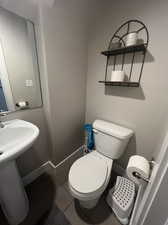 1/2 Bathroom by kitchen/laundry and garage with tiled floors