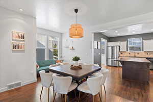 Dining area featuring dark hardwood / wood-style floors, sink, a wealth of natural light, and a textured ceiling