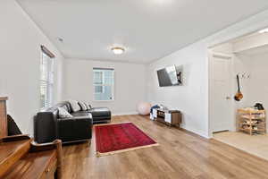 Living room with hardwood / wood-style flooring