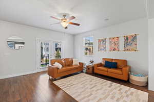 Living room featuring french doors, plenty of natural light, dark hardwood / wood-style floors, and ceiling fan