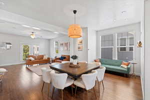 Dining space featuring dark hardwood / wood-style floors and ceiling fan