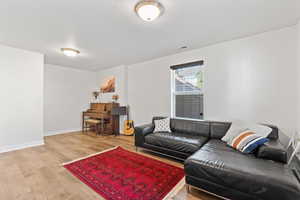 Living room with light hardwood / wood-style floors