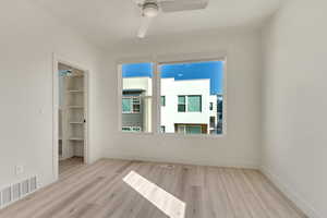 Spare room featuring ceiling fan and light wood-type flooring