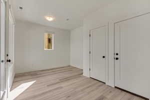 Unfurnished bedroom featuring light wood-type flooring