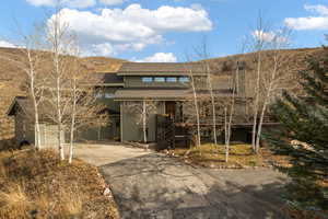 View of front facade with covered porch and a garage