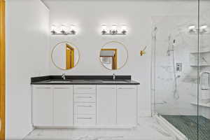 Bathroom with vanity and a shower with shower door