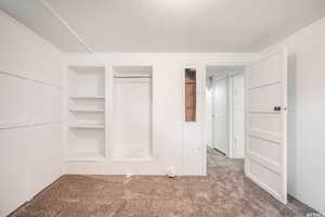 Unfurnished bedroom with light colored carpet