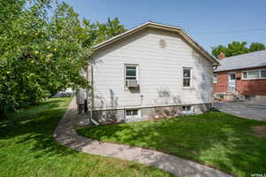 View of property exterior featuring a yard