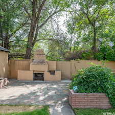 View of patio / terrace featuring an outdoor stone fireplace