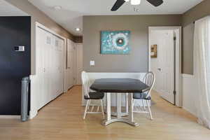 Dining room with ceiling fan and light hardwood / wood-style floors