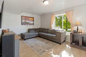 Living room featuring light hardwood / wood-style flooring and a textured ceiling