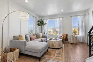 Living room with a textured ceiling and hardwood / wood-style floors