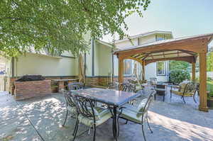 View of patio / terrace featuring a gazebo and an outdoor living space with a fire pit