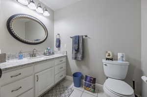 Bathroom with tile patterned floors, vanity, and toilet