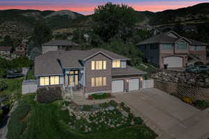 View of front of house with a mountain view and a garage