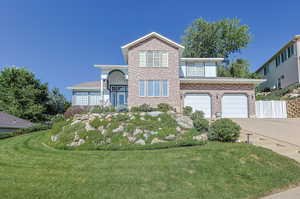 View of front property with a garage and a front yard