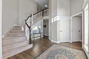 Entryway featuring laminate/wood-style floors,and a towering ceiling