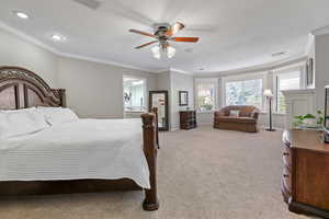 Bedroom featuring ceiling fan, carpet floors, and crown molding